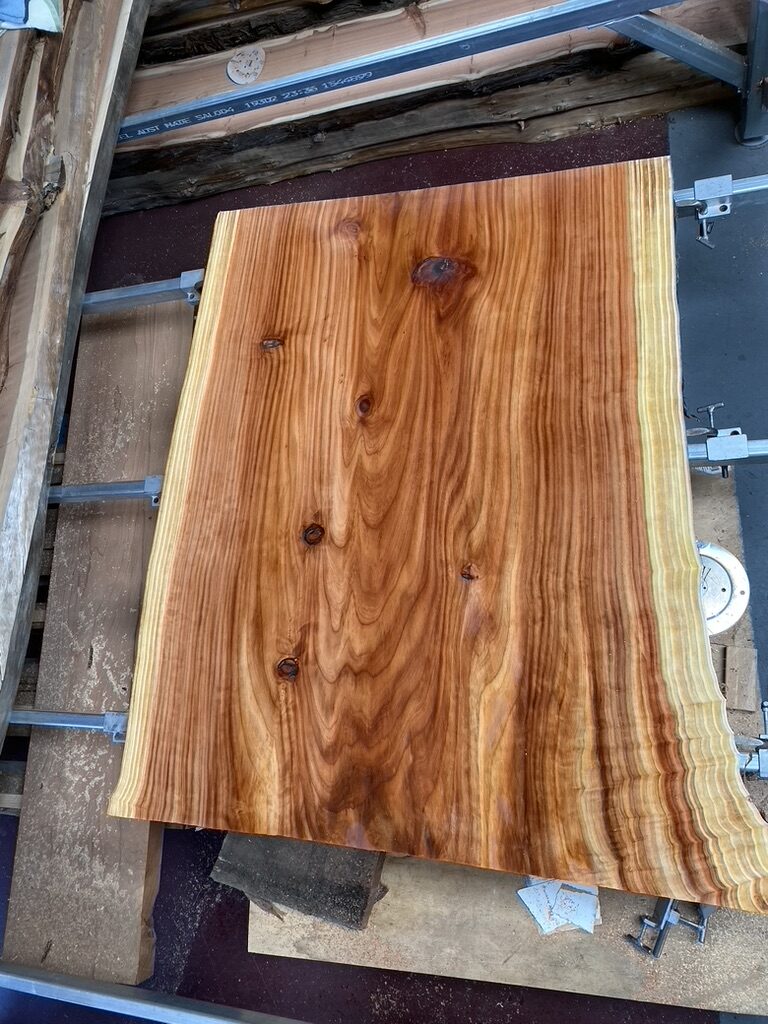 Finished live edge slab with rich grain and sapwood edge