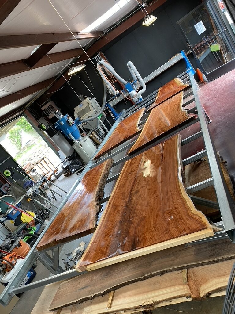 Finished live edge slabs staged in the shop