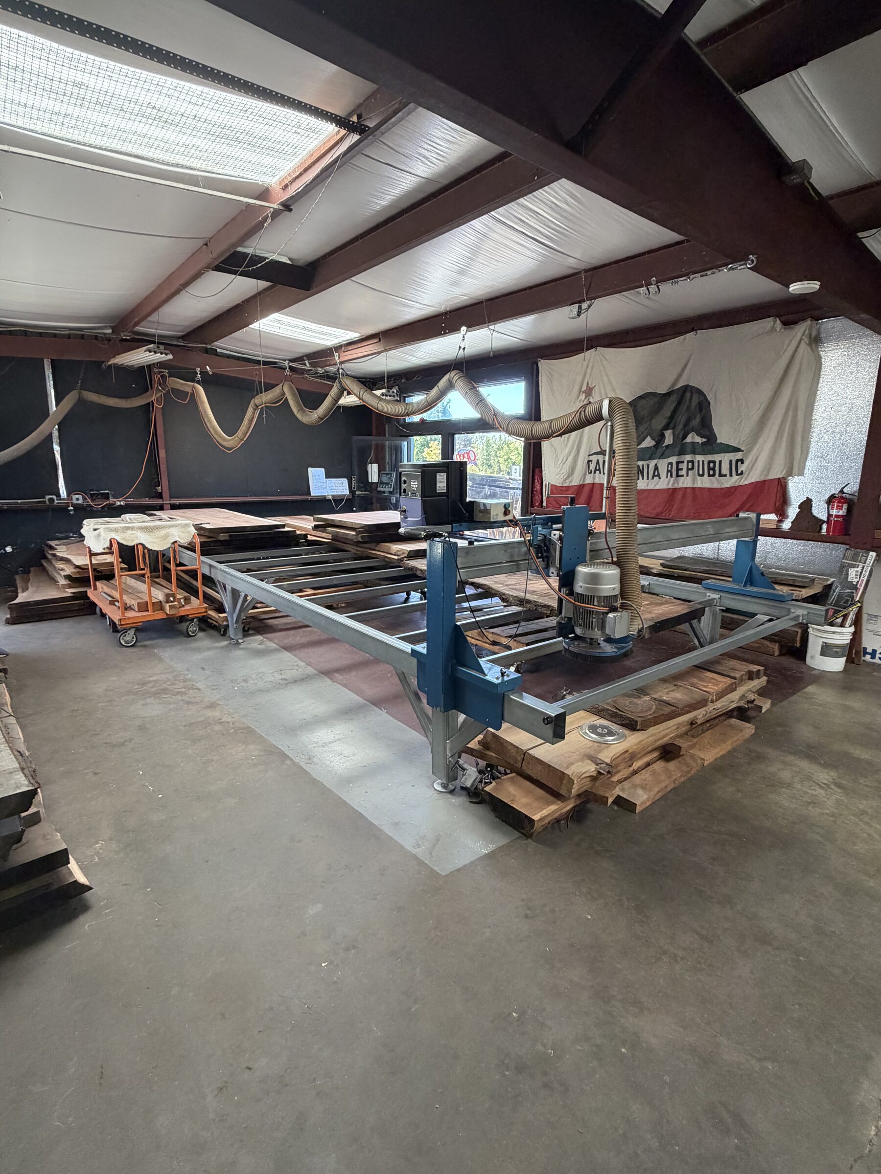Live edge slabs on the fabrication mill in the shop